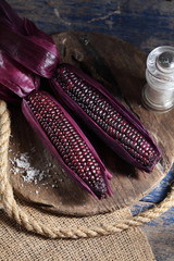 Boiled purple corn on wooden tray in rustic kitchen, Organic sweet purple corn