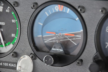 Single engine piston aircraft attitude indicator close up shot during turn, orange indication with...