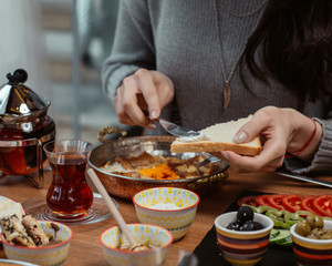 woman smears butter on bread