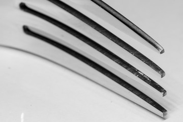 Abstract image of a silver fork with a shadow