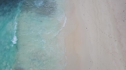 Fototapeta na wymiar Waves wash sea shore in Seychelles beatiful footage 4K