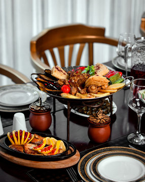 various fried meat and vegetables on sadj