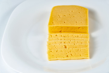 Cheese Sliced on White Plate