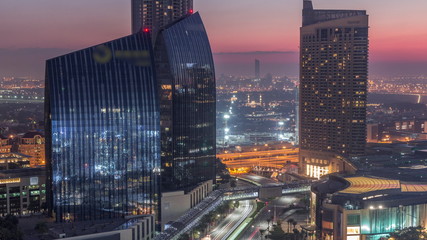 Fototapeta na wymiar Dubai downtown street with busy traffic and skyscrapers around night to day timelapse.