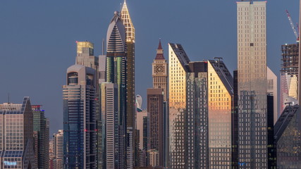 Obraz premium Aerial view of new skyscrapers and tall buildings in Dubai day to night timelapse