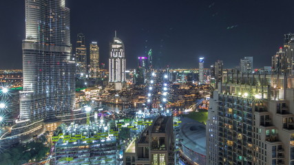 Panoramic skyline view of Dubai downtown with mall, fountains and skyscrapers aerial night timelapse