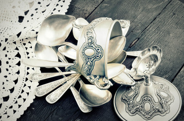 vintage old silverware on a wooden table,tinted