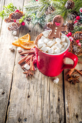 Christmas hot chocolate red mug with melted chocolate gingerbread man. Funny Christmas drink for holidays. With xmas decoration copy space