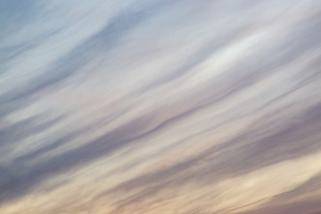 Looking up at a full frame photograph of wispy clouds and sky