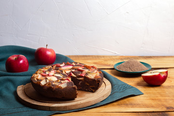 Gluten pie with flax flour and apples on green cloth and wood table