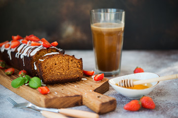 Delicious honey cake for tea decorated with sugar Fudge and fresh red strawberries.  Horizontal orientation.