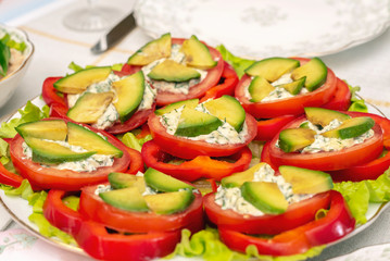 Assorted fresh vegetables with avocado, bell peppers, tomatoes and yoghurt sauce
