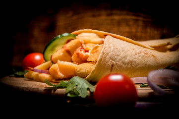 caesar roll close up. wooden background. juicy tomatoes in the foreground