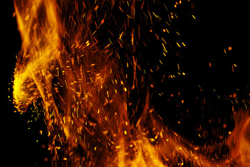 Fototapeta na wymiar flame of fire with sparks on a black background