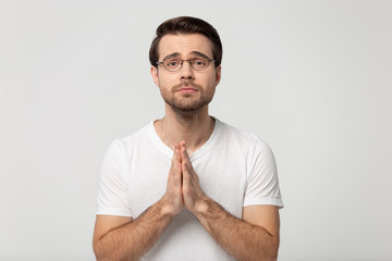 Hopeful Caucasian man look at camera begging