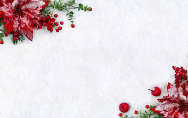 Christmas decoration. Frame of flowers of red poinsettia, twigs christmas tree, red apples, red berries on snow with space for text. Top view, flat lay