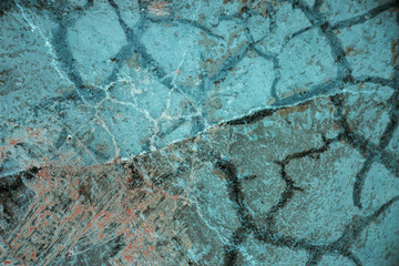 transparent texture of frozen water on the ground with large cracks