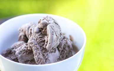 Melting chocolate ice cream in a white ceramic cup