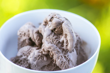 Melting chocolate ice cream in a white ceramic cup