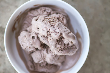 Melting chocolate ice cream in a white ceramic cup