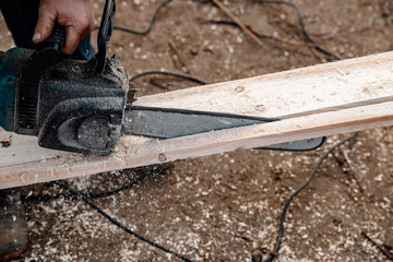 work with a power saw at wood