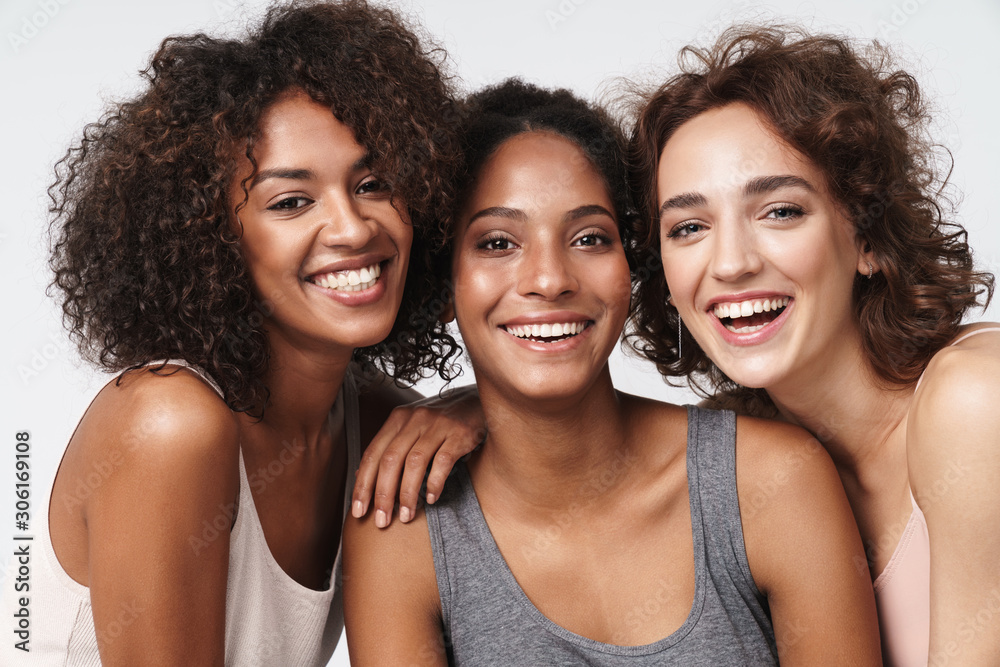 Wall mural portrait of young multiracial women standing together and smiling
