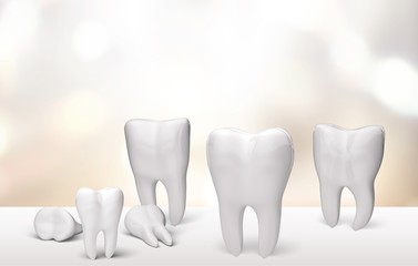 Many dentist white tooth on white desk with bokeh background