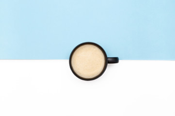 Flatlay coffee in the center of a blue and white background