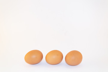 Three chicken eggs isolated on white background. Studio shot
