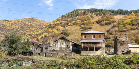 A single farm is located at the foot of the mountains in Svaneti in the mountainous part of Georgia in the early morning