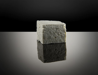 piece of feta cheese on black ground