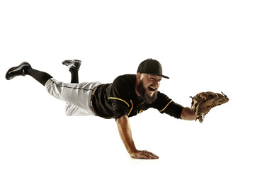 In flight. Baseball player, pitcher in black uniform practicing and training isolated on white background. Young professional sportsman in action and motion. Healthy lifestyle, sport, movement concept