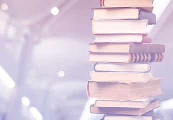 Stack of colorful books on interior background