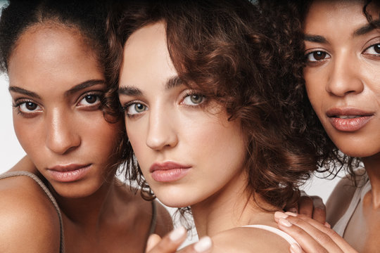 Close up beauty portrait of three attractive young sensual multiethnic women