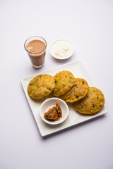 Methi Poori or Puri made using Fresh fenugreek leaves missed with wheat flour, by making small pancake size shapes deep fried in oil, served with tea