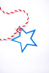 The blue star is connected with a festive red and white rope.