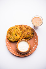 Methi Poori or Puri made using Fresh fenugreek leaves missed with wheat flour, by making small pancake size shapes deep fried in oil, served with tea