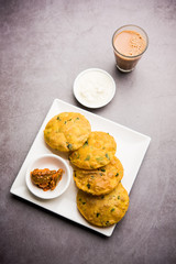 Methi Poori or Puri made using Fresh fenugreek leaves missed with wheat flour, by making small pancake size shapes deep fried in oil, served with tea