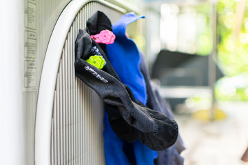 Dry the socks quickly by clamping it with the air conditioner compressor