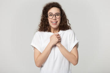 Excited millennial girl in glasses feel overjoyed with news