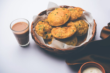 Methi Poori or Puri made using Fresh fenugreek leaves missed with wheat flour, by making small pancake size shapes deep fried in oil, served with tea