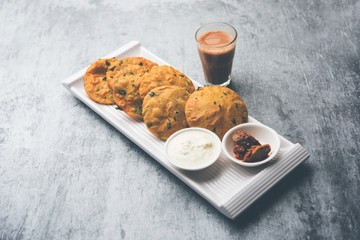 Methi Poori or Puri made using Fresh fenugreek leaves missed with wheat flour, by making small pancake size shapes deep fried in oil, served with tea