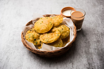 Methi Poori or Puri made using Fresh fenugreek leaves missed with wheat flour, by making small pancake size shapes deep fried in oil, served with tea