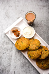 Methi Poori or Puri made using Fresh fenugreek leaves missed with wheat flour, by making small pancake size shapes deep fried in oil, served with tea