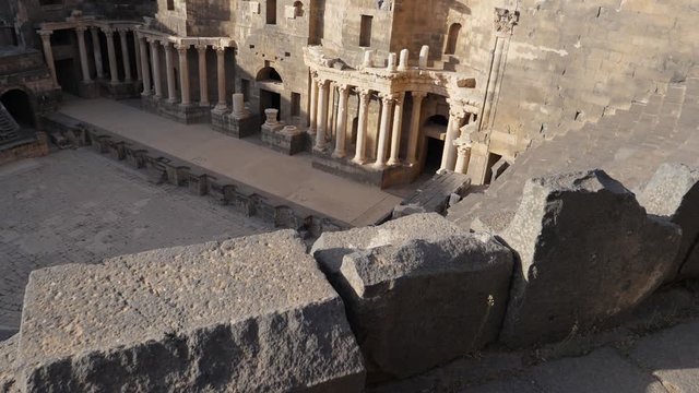 Top view slow motion shot, moving forward towards the view of Bosra Amphitheater in Syria Jordan.