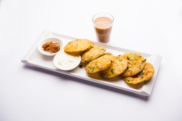 Methi Poori or Puri made using Fresh fenugreek leaves missed with wheat flour, by making small pancake size shapes deep fried in oil, served with tea