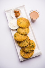 Methi Poori or Puri made using Fresh fenugreek leaves missed with wheat flour, by making small pancake size shapes deep fried in oil, served with tea