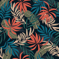 Summer seamless tropical pattern with bright orange and blue plants and leaves on a black background. Seamless exotic pattern with tropical plants.  Summer colorful hawaiian seamless pattern.