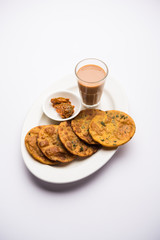 Methi Poori or Puri made using Fresh fenugreek leaves missed with wheat flour, by making small pancake size shapes deep fried in oil, served with tea