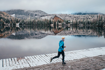 Fototapeta na wymiar Running in winter, sport photo, beautiful white nature, active man train in winter morning